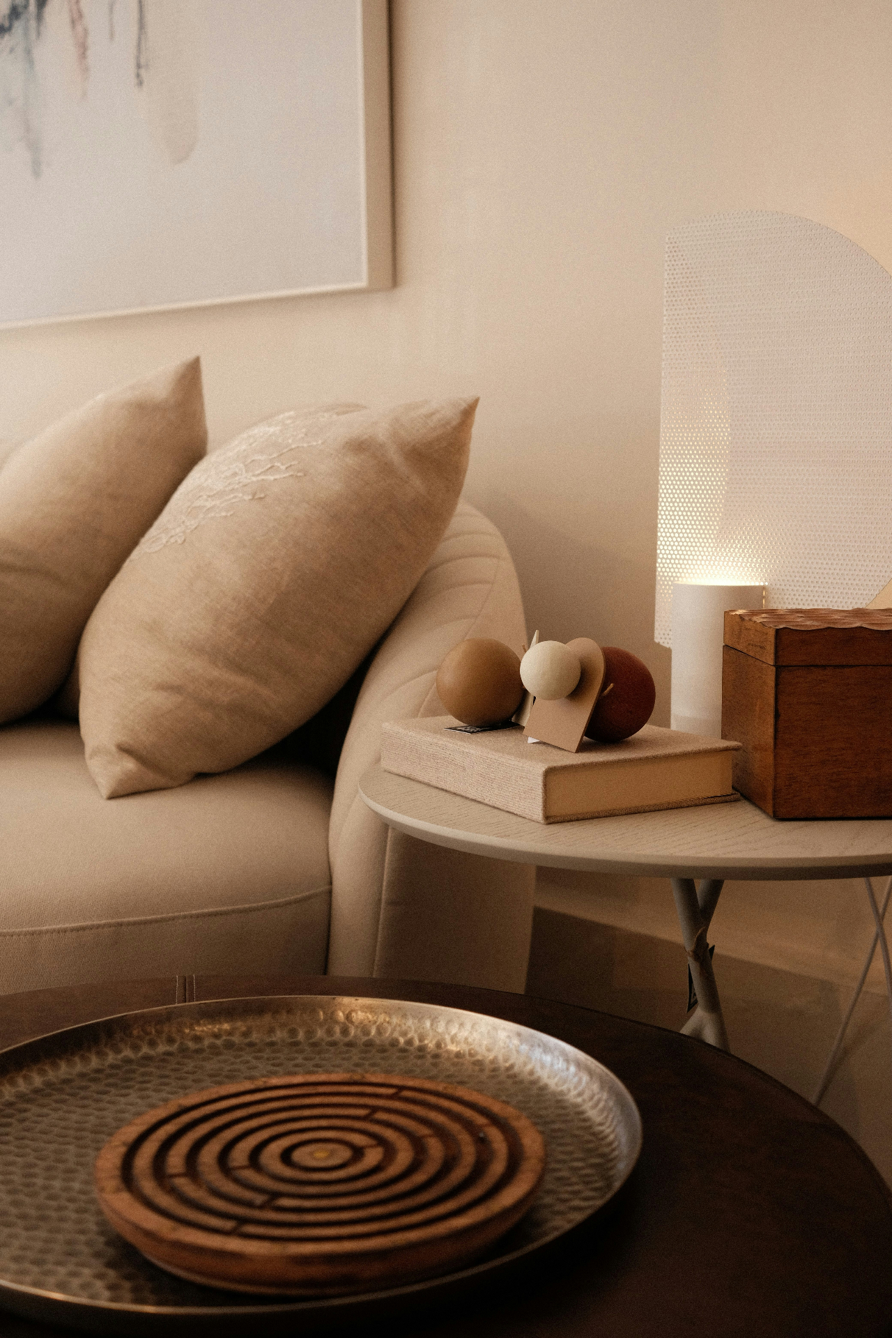 A quiet, warmly lit sitting room with linen cushions and natural textures